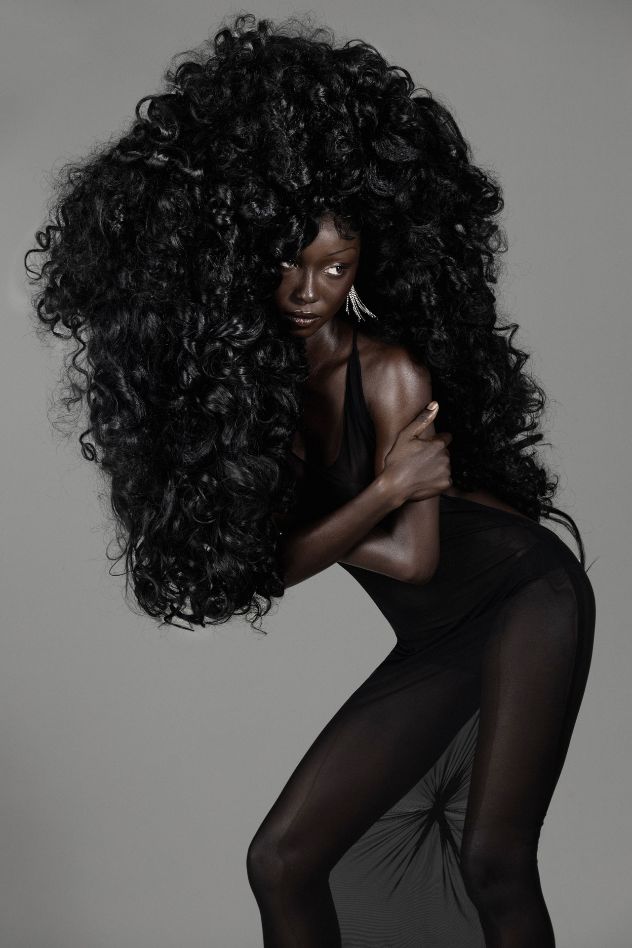 Seated portrait in sheer black fabric