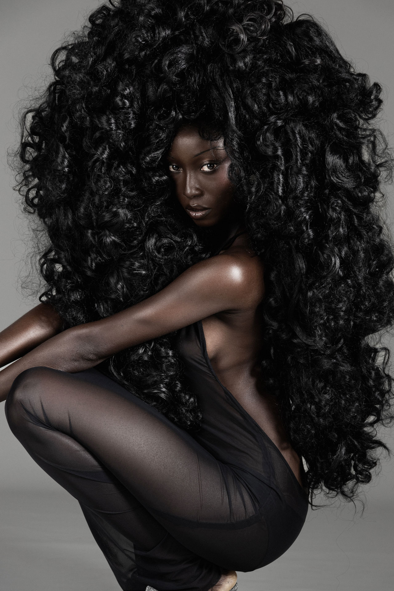 Crouched portrait in sheer black fabric