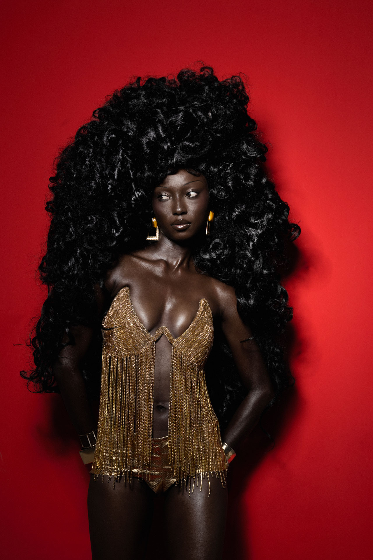 Gold fringed top against a red background