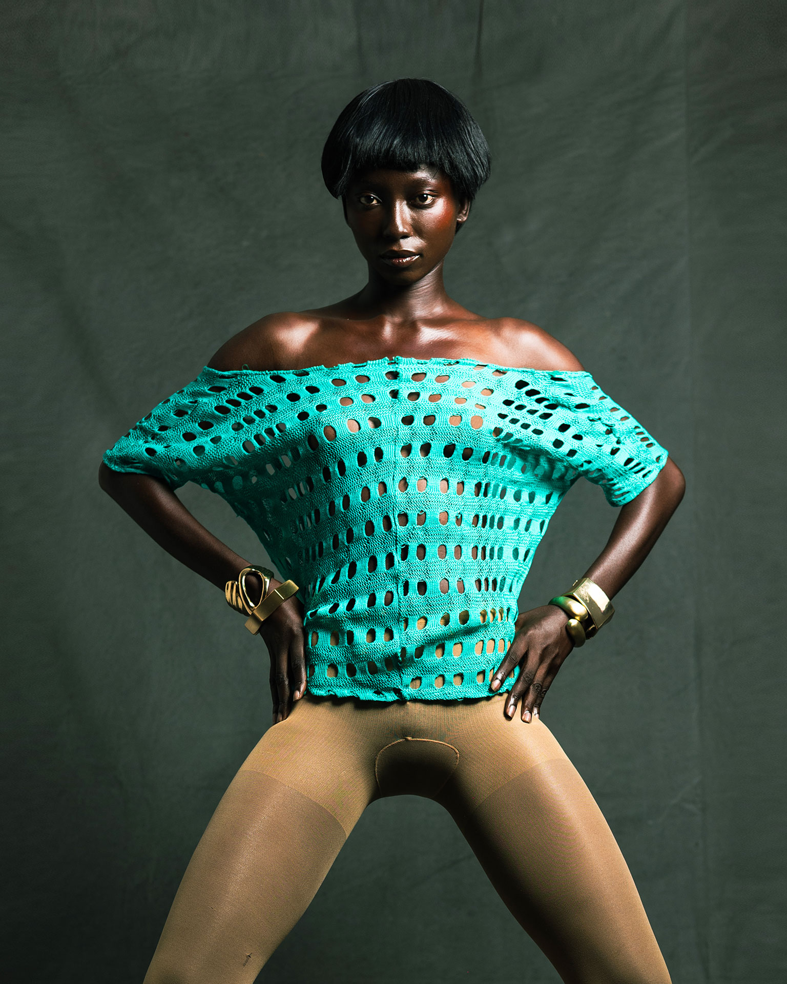 Standing studio pose with hands at the waist