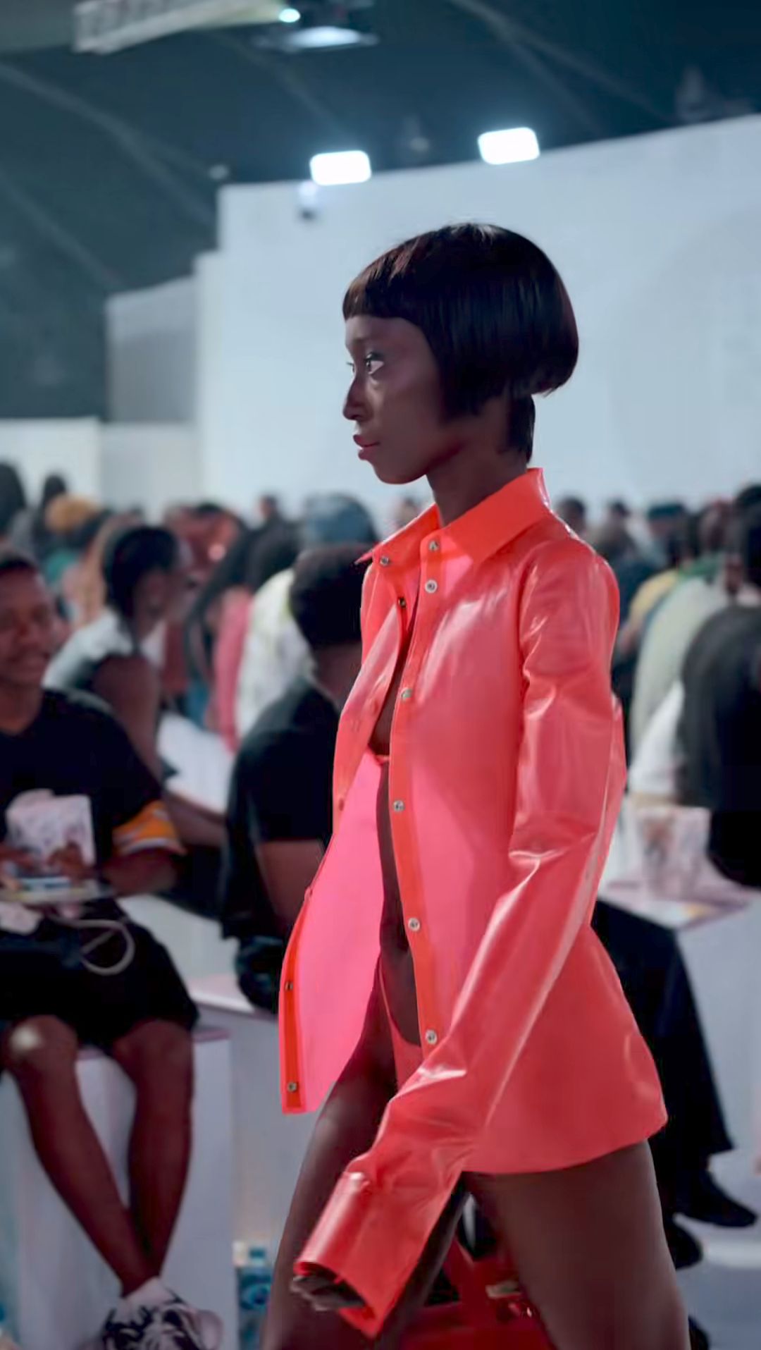 Close runway view of the pink-red shirt and bag