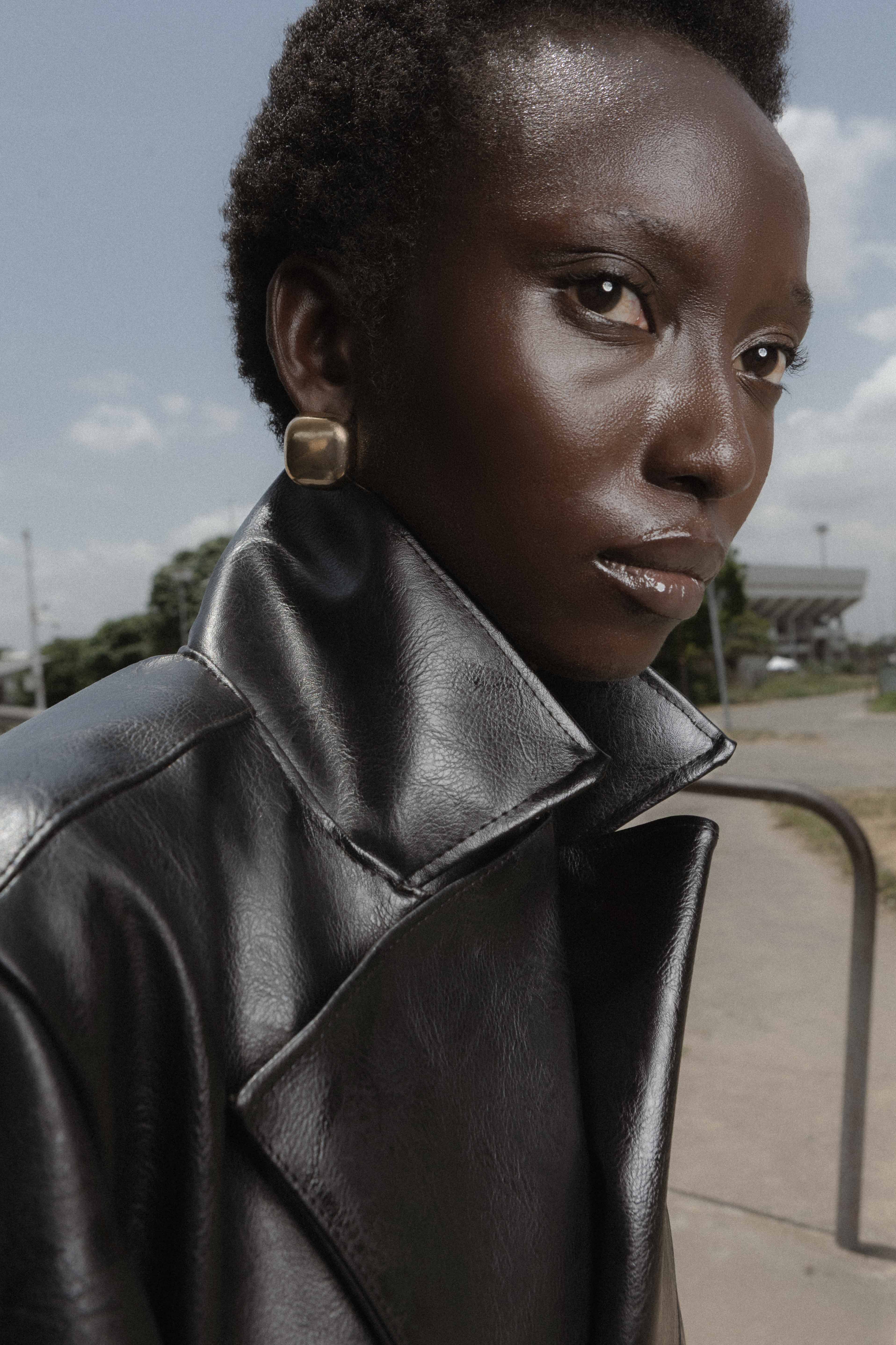 Close outdoor portrait with a high black coat collar