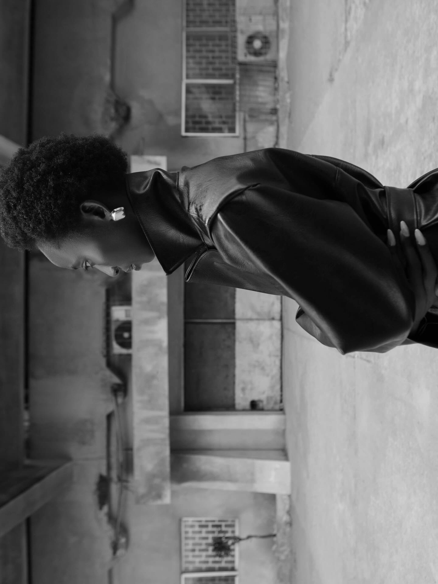 Landscape black-and-white side portrait beside concrete