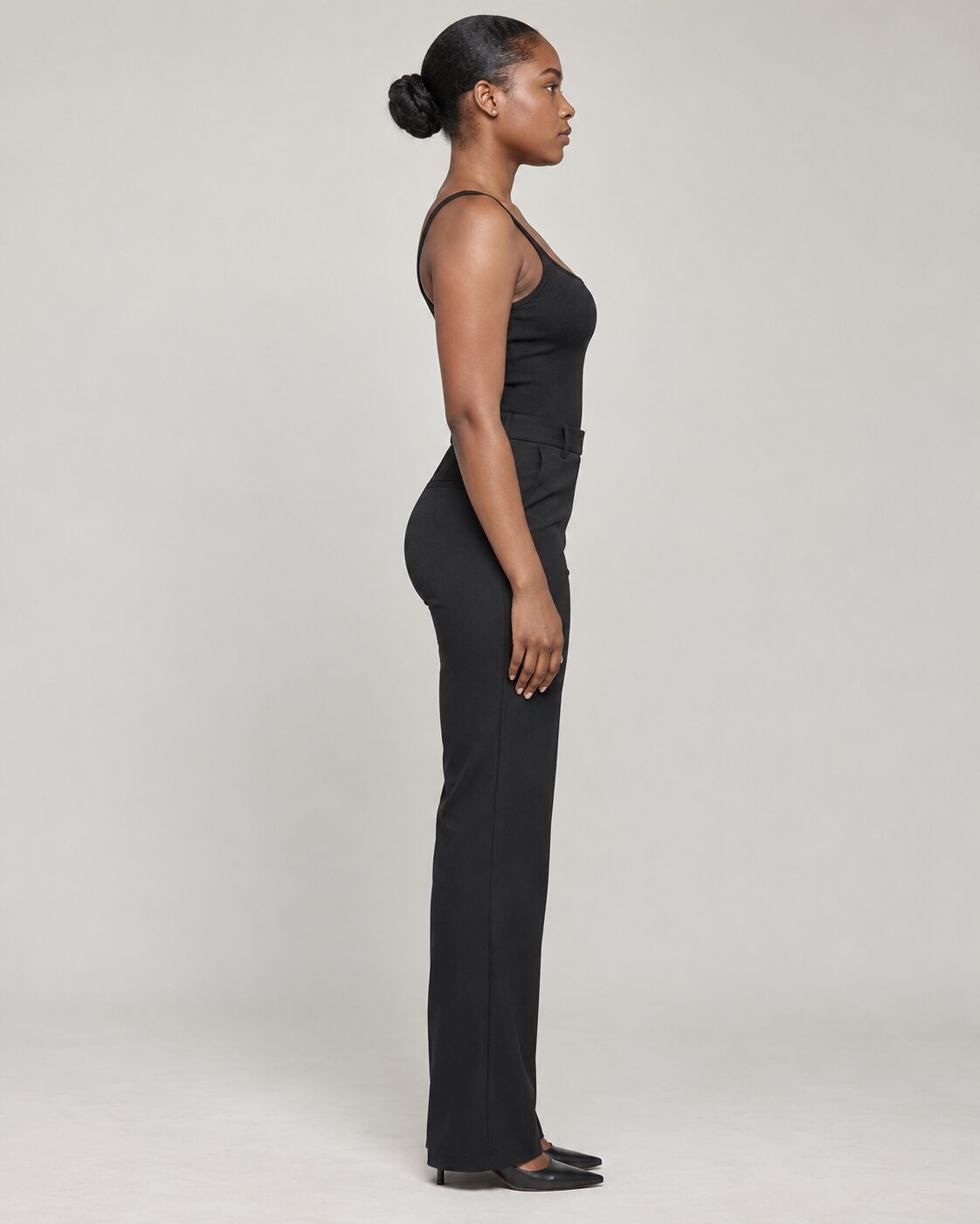 Full-length side profile in a simple black outfit, generated portfolio reference